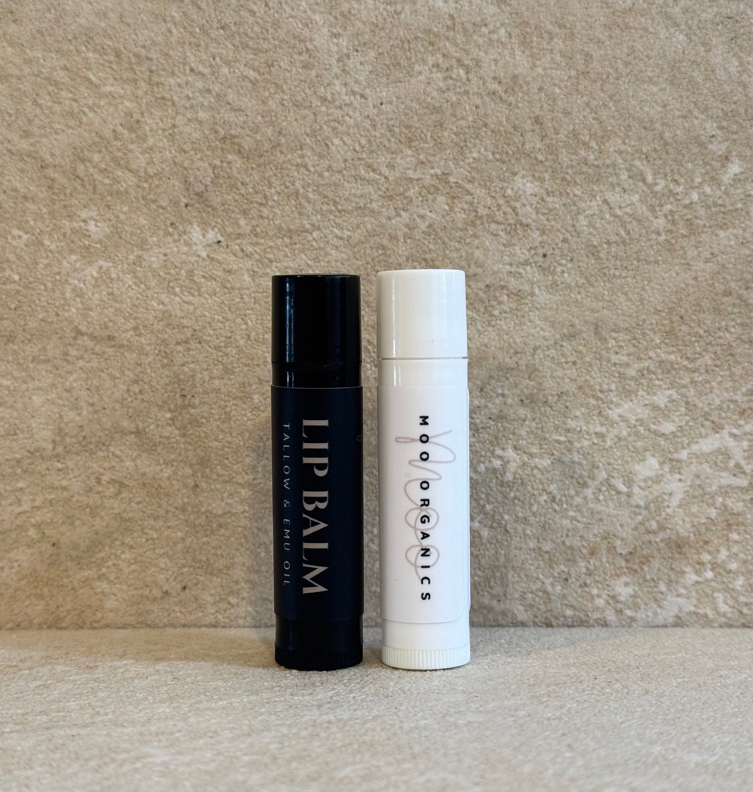 2 varieties of lip balm, black & White tubes.