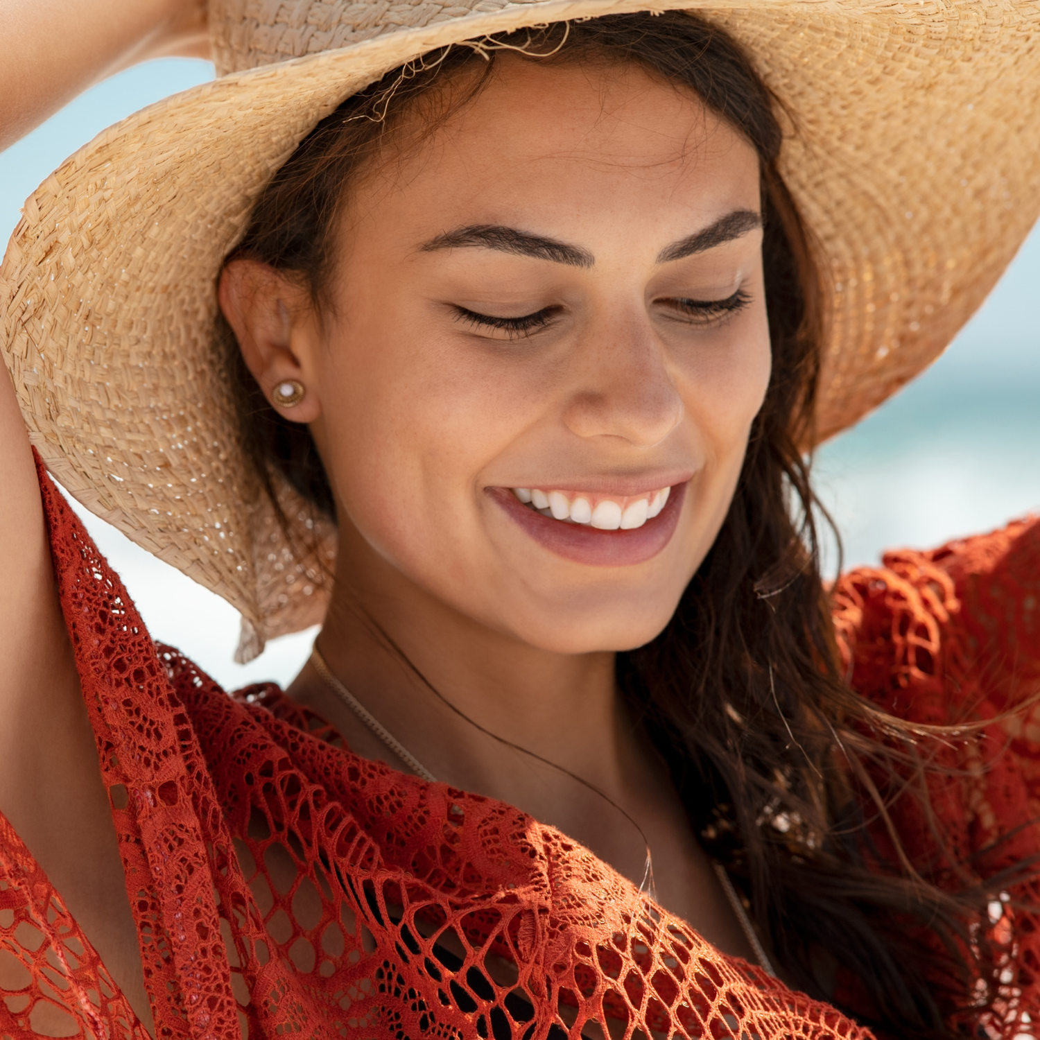MOO Beach Girl tallow skincare product with a sun hat on the beach, made with grass-fed beef tallow to naturally nourish and protect skin, showcasing a sun-ready, clean, and natural lifestyle