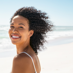 MOO Girl Beach Clear Skin image featuring a model with healthy, glowing skin on the beach, representing the nourishing effects of grass-fed beef tallow skincare products