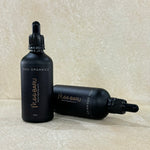 Two bottles of MOO BARU hydrating serum with black caps and labels, one standing upright and the other lying down, on a beige background.